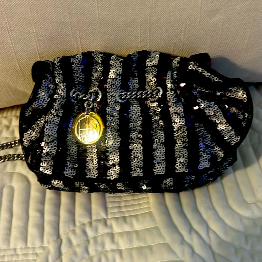 Henri Bendel Clutch, silver wrist strap purse Sequin Embellishment
Silk Lining